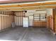 Spacious garage with an automatic door opener, built-in storage shelves, cabinets, and a refrigerator at 11375 W Maplewood Ave, Littleton, CO 80127