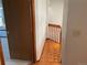 Hallway showing access to the staircase and a bedroom at 11375 W Maplewood Ave, Littleton, CO 80127