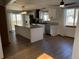 Updated kitchen featuring an island, stainless steel appliances, and sliding glass door to the exterior at 11375 W Maplewood Ave, Littleton, CO 80127