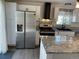 Eat-in kitchen with stainless steel appliances, granite counters and island at 11375 W Maplewood Ave, Littleton, CO 80127
