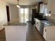 Bright kitchen features stainless steel appliances, granite countertops, and a spacious island for food prep at 11375 W Maplewood Ave, Littleton, CO 80127