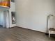 Open concept living room featuring a large window and vinyl flooring at 11375 W Maplewood Ave, Littleton, CO 80127