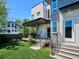 A backyard featuring a patio area with string lights, and lush green grass at 2508 S Pennsylvania St, Denver, CO 80210