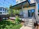 Back patio with overhead string lights and a staircase to the backyard at 2508 S Pennsylvania St, Denver, CO 80210