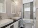 Elegant bathroom with double sinks, sleek vanity, and stylish tiled shower and tub at 2508 S Pennsylvania St, Denver, CO 80210