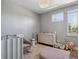 Calm Bedroom with modern crib, changing table, and ample natural light at 2508 S Pennsylvania St, Denver, CO 80210