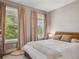 Cozy bedroom with neutral tones, natural light, and a comfortable bed at 2508 S Pennsylvania St, Denver, CO 80210