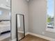 Bright bedroom featuring a large mirror and hardwood floors, offering a modern and airy feel at 2508 S Pennsylvania St, Denver, CO 80210
