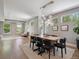 Dining space featuring a modern table, striking light fixture and views into the living area at 2508 S Pennsylvania St, Denver, CO 80210