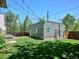 Backyard view of a detached garage and a well-maintained lawn at 2508 S Pennsylvania St, Denver, CO 80210