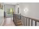 Upstairs hallway with modern railing, contemporary lighting, and a view to another room at 2508 S Pennsylvania St, Denver, CO 80210