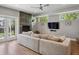 Bright living room with a modern fireplace, a plush couch, and doors to the yard at 2508 S Pennsylvania St, Denver, CO 80210