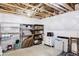 Unfinished basement with open ceiling and shelving for ample storage solutions at 8917 Yates Dr, Westminster, CO 80031