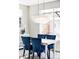 Bright dining room features stylish chandelier over a modern dining table with blue, upholstered chairs at 8917 Yates Dr, Westminster, CO 80031