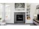 Stylish fireplace with modern tile surround, complemented by built-in shelving for added storage and decor at 8917 Yates Dr, Westminster, CO 80031