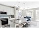 Modern kitchen with sleek countertops, stainless steel appliances, and a stylish island with seating at 8917 Yates Dr, Westminster, CO 80031