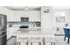 Modern kitchen with stainless steel appliances, a large island, and stylish pendant lighting at 8917 Yates Dr, Westminster, CO 80031