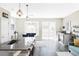 Bright, open kitchen featuring a spacious island, modern lighting, and seamless flow to the dining area at 8917 Yates Dr, Westminster, CO 80031
