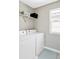 Well-lit laundry room featuring white washer and dryer and ample storage space at 8917 Yates Dr, Westminster, CO 80031
