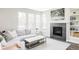 Bright living room featuring a cozy fireplace, large windows, and stylish decor for comfortable living at 8917 Yates Dr, Westminster, CO 80031