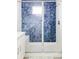 Modern shower with a glass door and blue decorative tile and built in bench at 8917 Yates Dr, Westminster, CO 80031