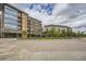 View of town center with condos, shops, and tree-lined walkways at 8917 Yates Dr, Westminster, CO 80031