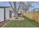 Lush green backyard with a stone patio perfect for outdoor dining and relaxation by mature tree at 3379 S Eliot St, Englewood, CO 80110