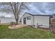 Well-manicured backyard featuring a small patio area and air conditioning unit at 3379 S Eliot St, Englewood, CO 80110