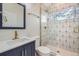 Stylish bathroom with modern fixtures, patterned tile shower, and a sleek vanity sink at 3379 S Eliot St, Englewood, CO 80110