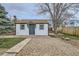 Charming home with gravel driveway, manicured lawn, and outdoor seating area, perfect for relaxation at 3379 S Eliot St, Englewood, CO 80110