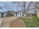 Cozy home featuring a gravel driveway, well-maintained lawn, and an inviting outdoor seating area at 3379 S Eliot St, Englewood, CO 80110