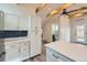 Bright kitchen featuring white cabinets, a stylish backsplash, and stainless steel appliances, open layout at 3379 S Eliot St, Englewood, CO 80110