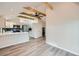 Open-concept space with vaulted ceilings, exposed beams, modern ceiling fan and stylish flooring at 3379 S Eliot St, Englewood, CO 80110