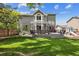 The backyard features a large deck perfect for outdoor entertaining and well-manicured green lawn at 9478 Burgundy Cir, Highlands Ranch, CO 80126