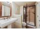 Bathroom featuring a pedestal sink, toilet, and glass-enclosed shower stall at 9478 Burgundy Cir, Highlands Ranch, CO 80126