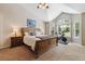 Bedroom with large windows, neutral carpet, and a stationary bike at 9478 Burgundy Cir, Highlands Ranch, CO 80126