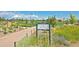 The Civic Green Park shows flower beds, walking trails, and open grassy area on sunny day at 9478 Burgundy Cir, Highlands Ranch, CO 80126