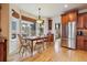 Cozy dining room with a bay window, stainless steel refrigerator, and natural light at 9478 Burgundy Cir, Highlands Ranch, CO 80126