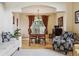 A charming dining area with hardwood floors features a window, table, and unique decor at 9478 Burgundy Cir, Highlands Ranch, CO 80126