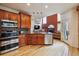 Bright kitchen features wood cabinets, stainless steel appliances, and hardwood floors at 9478 Burgundy Cir, Highlands Ranch, CO 80126