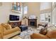 Bright living room with a fireplace, large windows, and a balcony, perfect for relaxation and entertaining at 9478 Burgundy Cir, Highlands Ranch, CO 80126