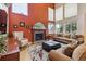 Living room boasts a fireplace, high ceilings, and ample natural light at 9478 Burgundy Cir, Highlands Ranch, CO 80126