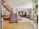Inviting living room with hardwood floors, natural light, staircase, and open floor plan at 9478 Burgundy Cir, Highlands Ranch, CO 80126