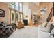 This bright, open living room boasts high ceilings, large windows, and neutral-toned furniture at 9478 Burgundy Cir, Highlands Ranch, CO 80126