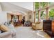 Open living room with large windows, hardwood floors, and neutral furnishings at 9478 Burgundy Cir, Highlands Ranch, CO 80126
