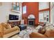 Inviting living room with hardwood floors, fireplace, comfortable furniture, and bright wall color at 9478 Burgundy Cir, Highlands Ranch, CO 80126