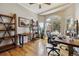 Sun-filled office with hardwood floors, large windows, and custom shelving at 9478 Burgundy Cir, Highlands Ranch, CO 80126