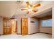 Finished basement featuring carpeted floors, wood trim, ceiling fan, and bright, inviting light at 2409 E Cedar Ave, Denver, CO 80209