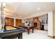 Finished basement featuring game tables, a fireplace, and hardwood trim at 2409 E Cedar Ave, Denver, CO 80209