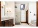 Bathroom with large glass shower, rain head, skylight, dark wood trim and cabinets, and a white countertop at 2409 E Cedar Ave, Denver, CO 80209